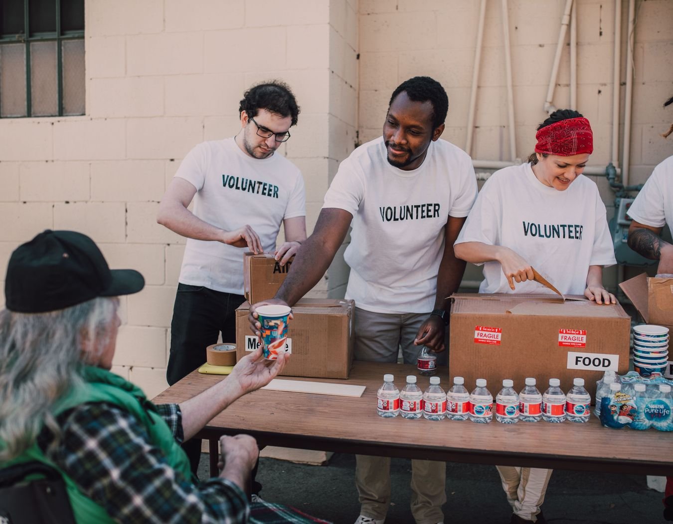 Employee volunteers organising aid boxes and water for a community event