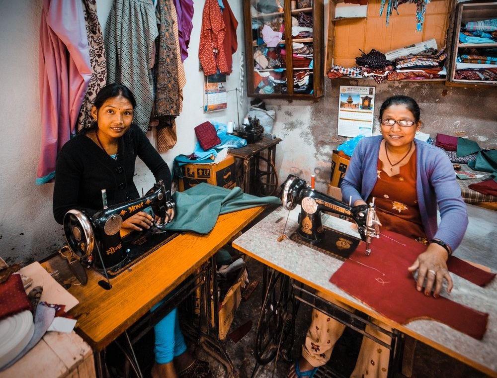 Women working in a livelihood and tailoring initiative supported through CSR