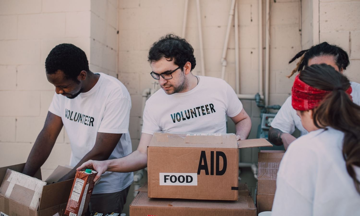 Volunteers joining hands during a community support event