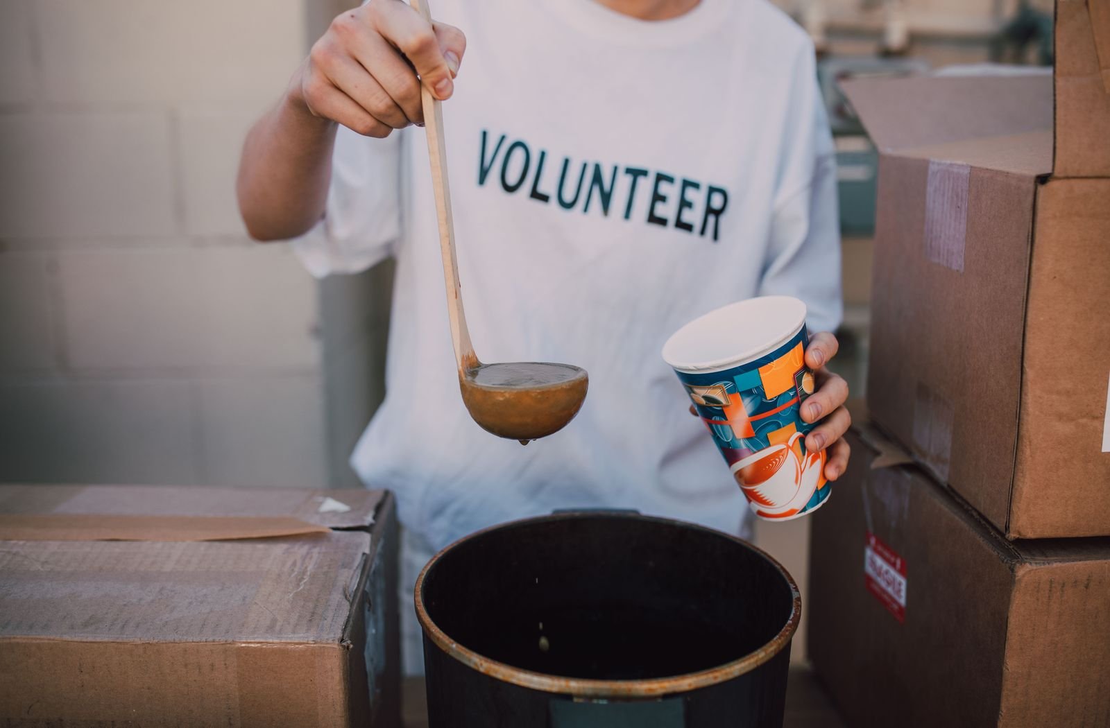 Volunteer serving a warm meal during a community food support activity