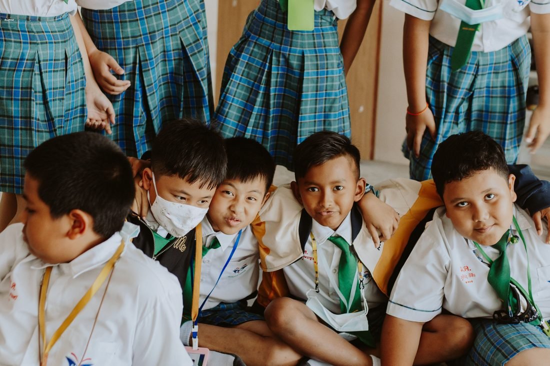 Group of school children sitting together and smiling