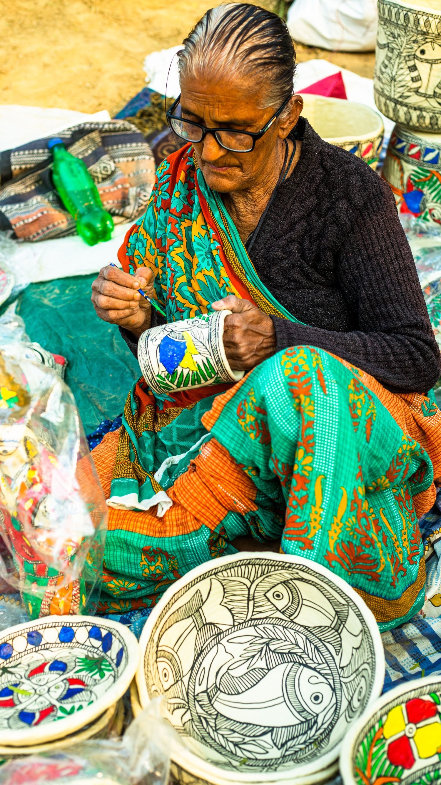 Indian woman artisan creating traditional hand-painted crafts